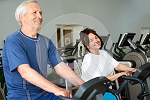 Senior couple spinning on fitness bikes.