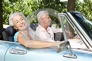 Senior couple in sports car