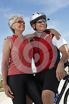 Senior Couple Standing By Bicycle