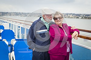 Senior Couple Standing On The Deck of a Cruise Ship