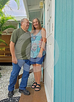 Senior couple standing at door