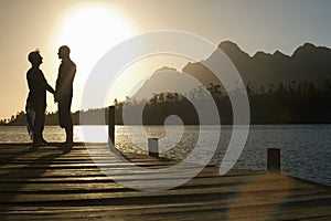 Senior Couple Standing On Edge Of Pier