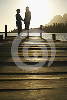 Senior Couple Standing On Edge Of Pier