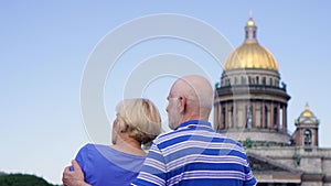 Senior couple standing near Saint Isaac`s Cathedral. Pensioners travel in Saint Petersburg, Russia