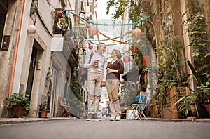 Senior Couple Strolling Through Lisbon's Streets Holding Coffee Cups Outdoor