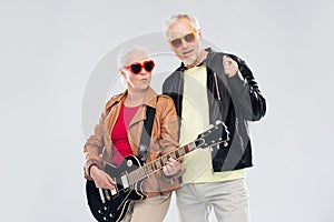 Senior couple in sunglasses with electric guitar