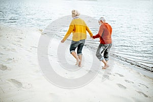 Senior couple in sweaters on the seashore