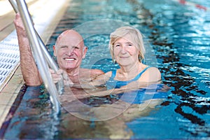Senior couple swimming in pool