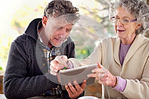 Senior couple, tablet or communication to relax on social media, website or bonding together. Older married people