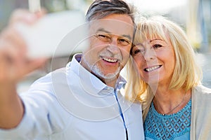 Senior couple taking selfie