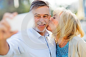 Senior couple taking selfie