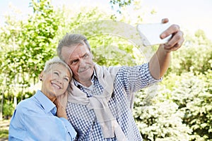 Senior Couple Taking Selfie in Park