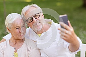 Senior couple taking selfie by smartphone at park