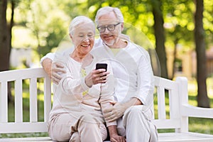 Senior couple taking selfie by smartphone at park