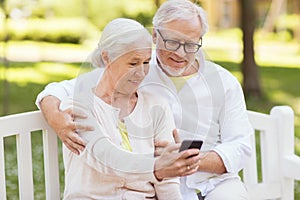 Senior couple taking selfie by smartphone at park