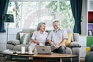 Senior couple talking with laptop computer