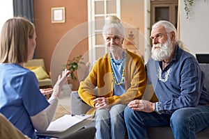 Senior couple talking to social worker