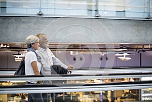 Senior couple traveling airport scene