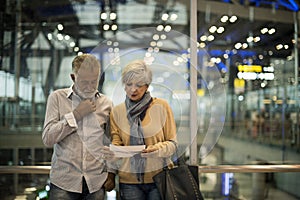 Senior couple traveling together in the airport scene