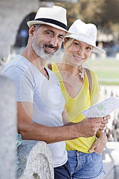 senior couple traveling together with city map