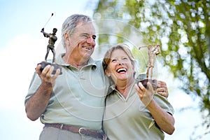 Senior couple, trophy or golfers with success for winning a sports tournament on golf course together. Excited, golfing