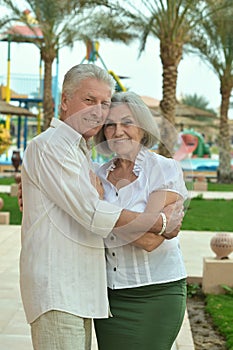 Senior couple at tropic hotel garden