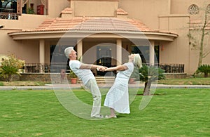 Senior couple at tropic hotel garden