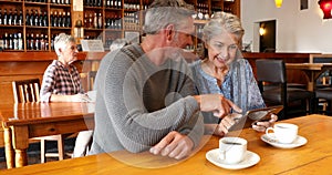 Senior couple using digital tablet in restaurant 4k
