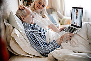 Senior couple using laptop