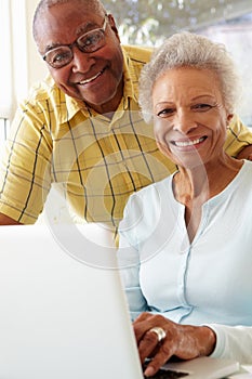 Senior Couple Using Laptop At Home