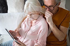 Senior couple using tablet together