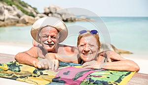 Senior couple vacationer having genuine fun on Koh Samui tropical beach in Thailand - Excursion tour in exotic scenario