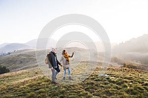 Senior couple on a walk in an autumn nature.