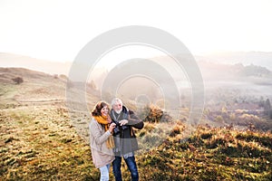 Senior couple on a walk in an autumn nature.