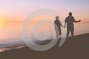 Senior couple walking along the beach