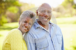 Senior Couple Walking Through Autumn Woodland