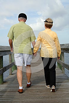 Senior couple walking back view