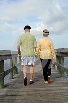 Senior couple walking back view