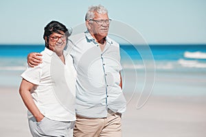 Senior couple walking on beach for love, care and relax on summer holiday in nature, sunshine or trust. Happy retirement