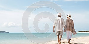 Senior couple walking on the beach on at sunny day, plan life insurance with the concept of happy retirement