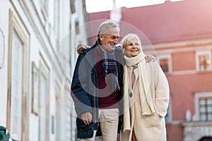 Senior couple walking on the city street at winter day