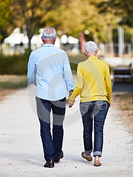 senior couple walking outdoors park talking love happy