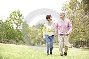 Senior Couple Walking In Park