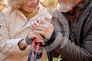 senior couple walking in park, sit having rest. Mature man and woman Happily smiling.