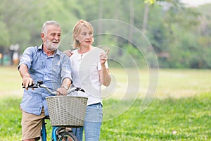 Senior couple walking their bike