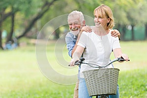 Senior couple walking their bike