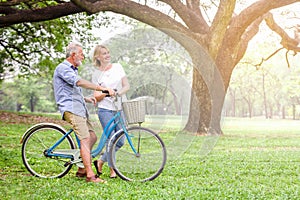 Senior couple walking their bike