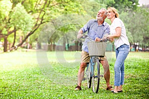 Senior couple walking their bike