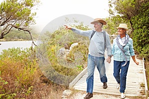 Senior couple walking together by a lake