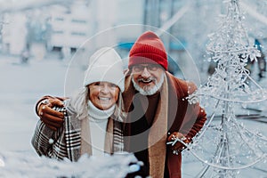 Senior couple walking in winter city center.